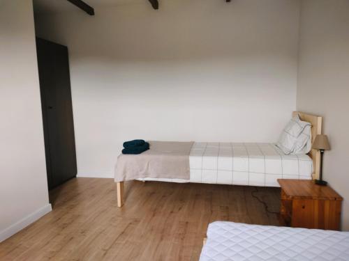 a bedroom with two beds and a wooden floor at Uroczysko Jakubowo in Dąbrówno