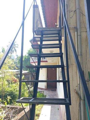 a wooden staircase leading up to a house at Residence Balanagala View Kandy in Katugastota