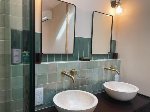 two sinks in a bathroom with two mirrors at Magnifique chambre pour une pause détente à Ahetze in Ahetze