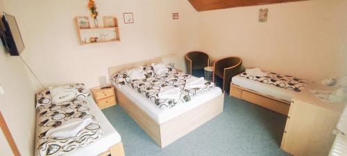 a room with two beds in a room at Pension Bílý Hořec in Vrchlabí