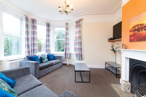 a living room with a couch and a fireplace at Thornbury Guest House Room 4 in Southampton