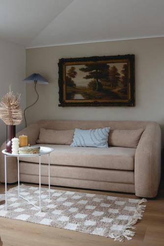 a living room with a couch and a table at B&B La Balena in Zaandijk near Amsterdam in Zaandijk