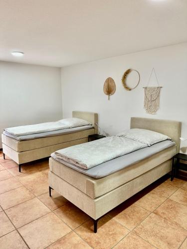 two beds sitting in a room with at Ferienwohnung in Ruppichteroth Winterscheid im EG mit Garten und Klima in Ruppichteroth
