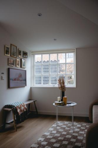 a living room with a table and a window at B&B La Balena in Zaandijk near Amsterdam in Zaandijk
