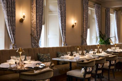 a dining room with tables and a couch at Francis Hotel Bath in Bath