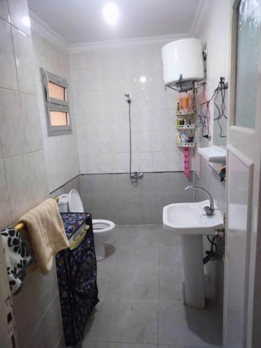 a bathroom with a sink and a toilet at Gadou Rooms in Port Said