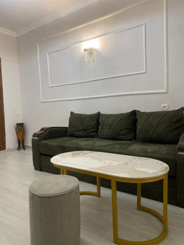 a living room with a couch and a coffee table at Shirakatsi Guest House in Gyumri