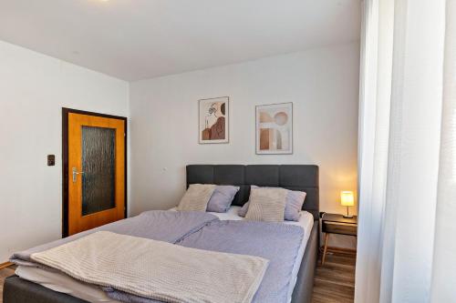 a bedroom with a large bed with a blue blanket at Fewo45 in Homberg