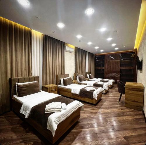Ένα ή περισσότερα κρεβάτια σε δωμάτιο στο Tashkent INN Arda