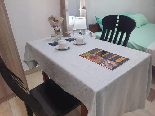 a table with a white table cloth on it at CANAAN MUSIC Hotel in Moratuwa