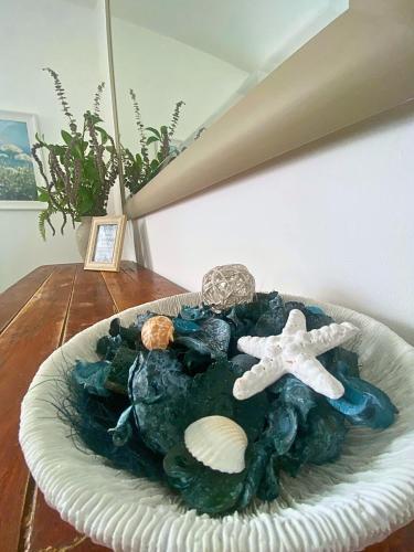 a plate with a seashell and an anchor on a table at Percy House, 2 Bedroom, 4 Bed Flat Near Beach, Porthcawl Town Centre in Porthcawl
