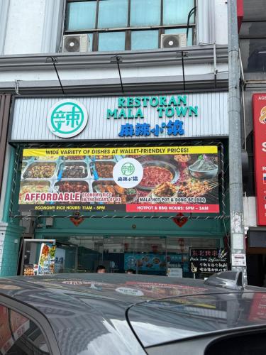 a restaurant with a sign on the side of a building at Agile TRX Luxury suite Bukit bintang in Kuala Lumpur