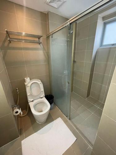 a bathroom with a toilet and a shower at Makati City Serenity Tower 2501 in Manila