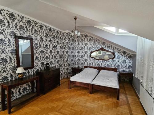 a bedroom with a bed and a mirror on a wall at Villa Wellness Budapest in Budapest