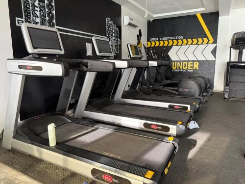 a gym with three treadmills and a treadmill at Shortlet Home in Lekki -Rehoboth Apartment in Lekki