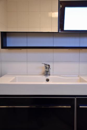 a sink in a bathroom with a sign above it at Villa Asteria in Samothraki