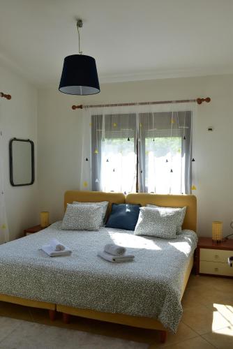a bedroom with a bed with two towels on it at Villa Asteria in Samothraki