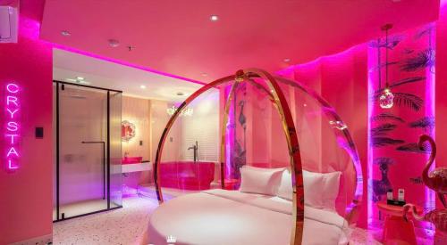 a room with a pink room with a bed in it at Ngan Le Mot Dem Hotel - Khach San 1001 Unique Love Hotel in Ho Chi Minh City