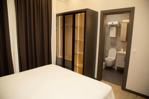 a bedroom with a bed and a bathroom with a toilet at Luxury Villa with Private Pool and Jacuzzi in Ortaca