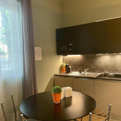 a small kitchen with a table and a sink at Bnbook Residence La Red in Rho