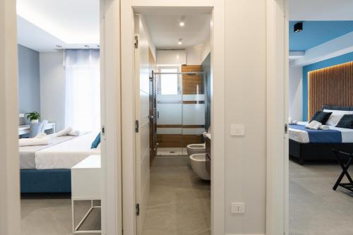a small room with two beds and a bathroom at Villa Cola - Vesuvio Garden & Relax in Boscotrecase
