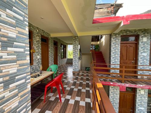a house with a staircase and a table and chairs at By The Way in Manāli