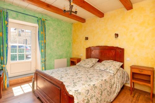 a bedroom with a bed and a large window at Maison avec grand jardin 10km plage in Férel