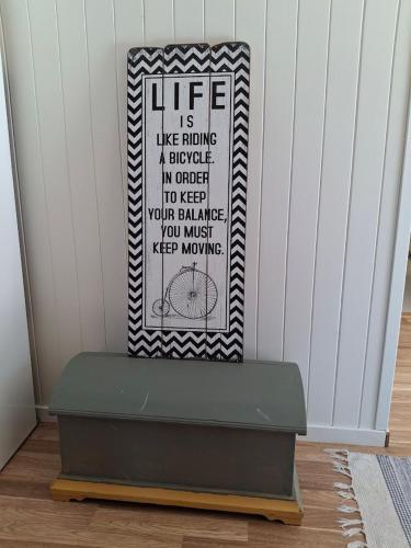 a bench with a sign on it in a room at Hillside - Adventure Norway in Bjelland