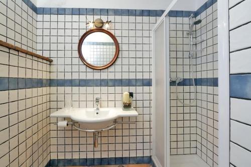 a bathroom with a sink and a mirror at Il Gallo d' Oro - Oca in Borgo Velino