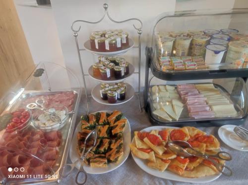 a buffet with different types of food on plates at Il Poderino in Monteriggioni