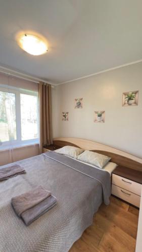 a bedroom with a large bed with two towels on it at База відпочинку «Павлоградець» in Orlovshchina