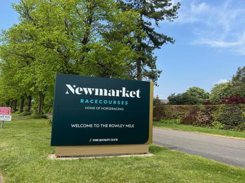 a sign for the newmarketazetazackackackagencyemeteryemeteryemetery at Newmarket Gem 5-Bedroom Home with Game Room and Cozy Spaces in Brinkley