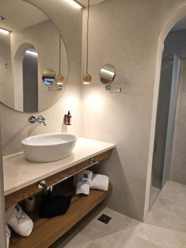 a bathroom with a sink and a mirror at Aegean Houses in Kos Town