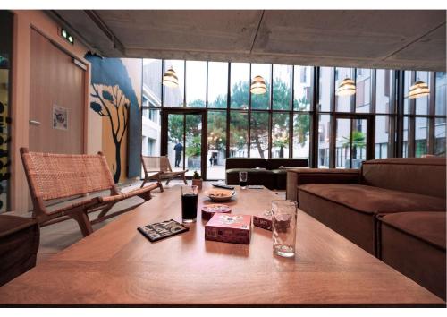 a living room with a wooden table and a couch at Résidence Nemea Montecristo in Nantes