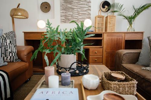a living room with a couch and a coffee table at The Palms Boutique Hotel in Hilton