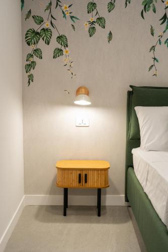 a bedroom with a bed and a table next to a bed at Villa Cola - Vesuvio Garden & Relax in Boscotrecase