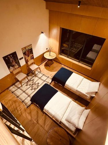 an overhead view of a bedroom with two beds and a table at The Himalayan Tyangboche in Lukla