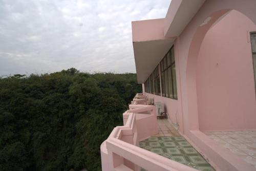 a balcony of a building with trees in the background at BIDV Hotel Đồ Sơn in Ðố Sơn