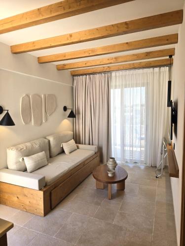 a living room with a couch and a table at Aegean Houses in Kos Town