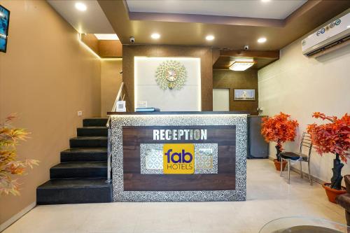 a lobby with a reception desk and stairs at FabExpress Tawakkal - Nr Phoenix Mall Kurla in Mumbai