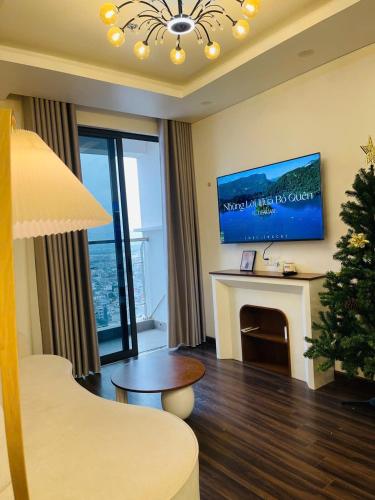 a living room with a christmas tree and a fireplace at LAD Apartment & Homestay Hải Phòng - Hoàng Huy Grand Tower in Hai Phong