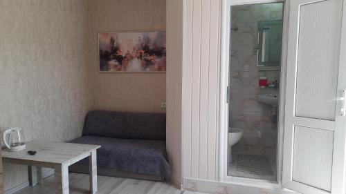 a living room with a couch and a table at Guesthouse Next to beach in Batumi