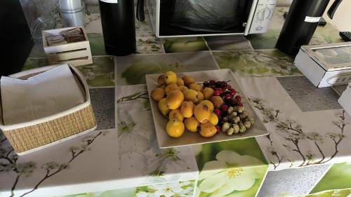 a table with a bowl of fruit on it at Small Luxury apartments Pool and sea view - Stella Del Mare in Fontane Bianche