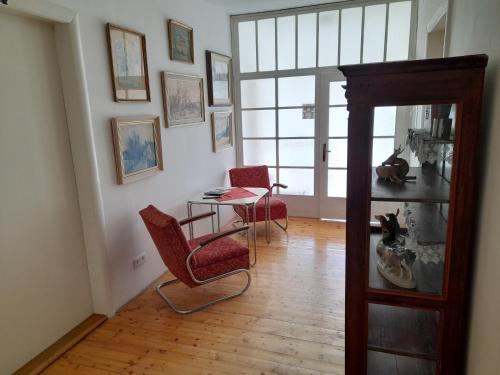 a living room with a table and two chairs at Ubytování pod Věží in Teplice nad Metují