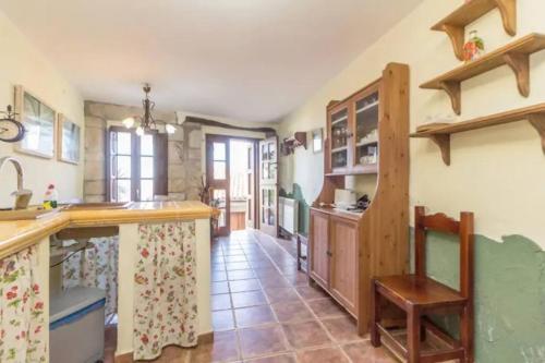 a large kitchen with a counter and a sink at La casina del Penayu in Lastres