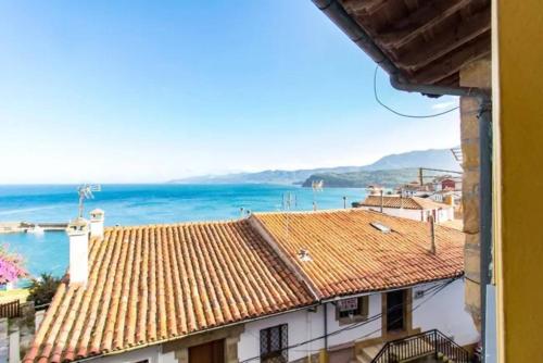 a view of the ocean from a building at La casina del Penayu in Lastres