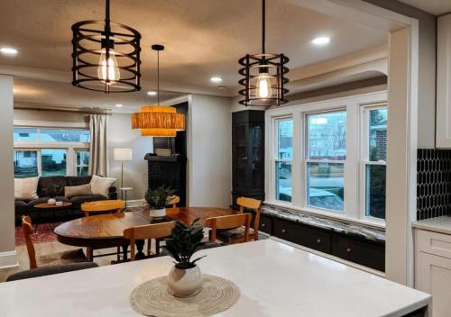 a kitchen and living room with two chandeliers at Large 4 Bedroom Recently Renovated With Hot Tub in Cleveland