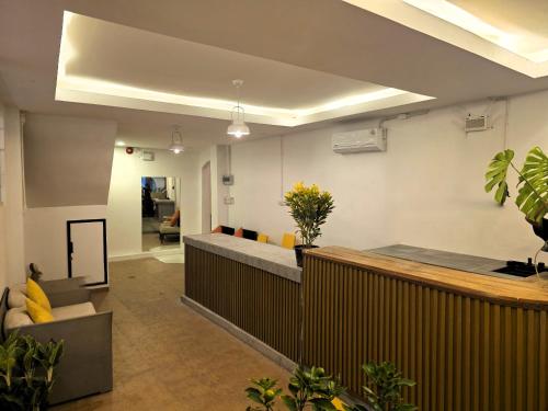 a living room with a couch and some plants at Hideout Hostel 2 in Haad Rin