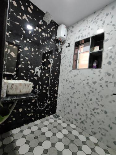 a bathroom with a shower with a sink and a mirror at Radiant villa in Panchgani