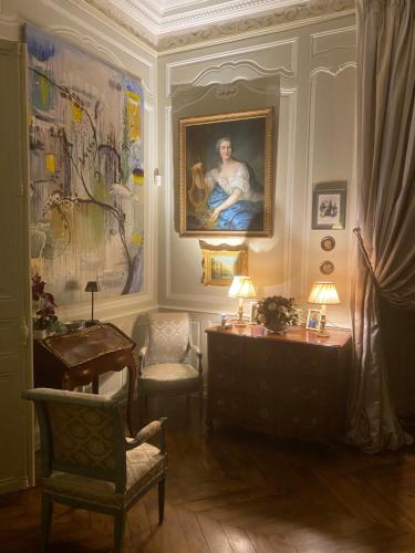 a living room with a painting and a desk and chair at Château de Bouesse en Berry in Bouesse